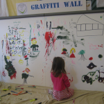 Child drawing on a wall