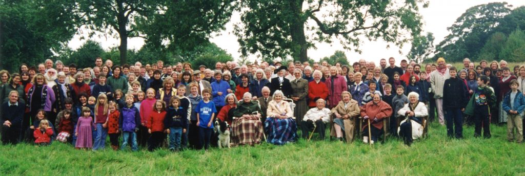 A group of people standing in front of a crowd posing for the camera