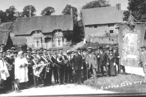 A group of people standing in front of a crowd posing for the camera