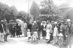 A group of people standing in front of a crowd posing for the camera