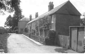 A house with a fence in front of a building