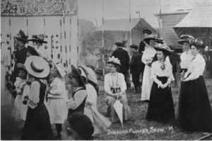 A vintage photo of a group of people posing for the camera