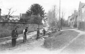 A group of people walking down a dirt road