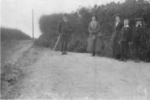 A group of people standing on top of a dirt field