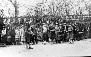 A group of people standing in front of a crowd