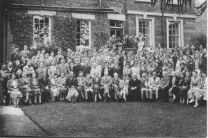 A group of people posing for a photo in front of a building