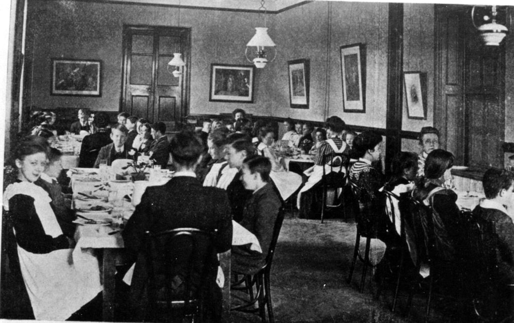 A vintage photo of a group of people sitting at a table