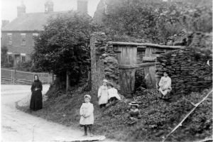A group of people standing in front of a house