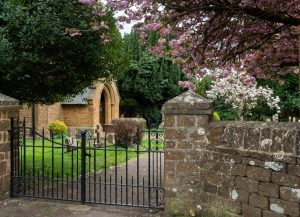 A gate in front of a brick wall