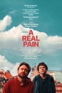 A man holding a sign posing for the camera