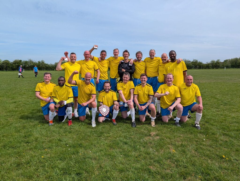 A group of people in a field posing for the camera